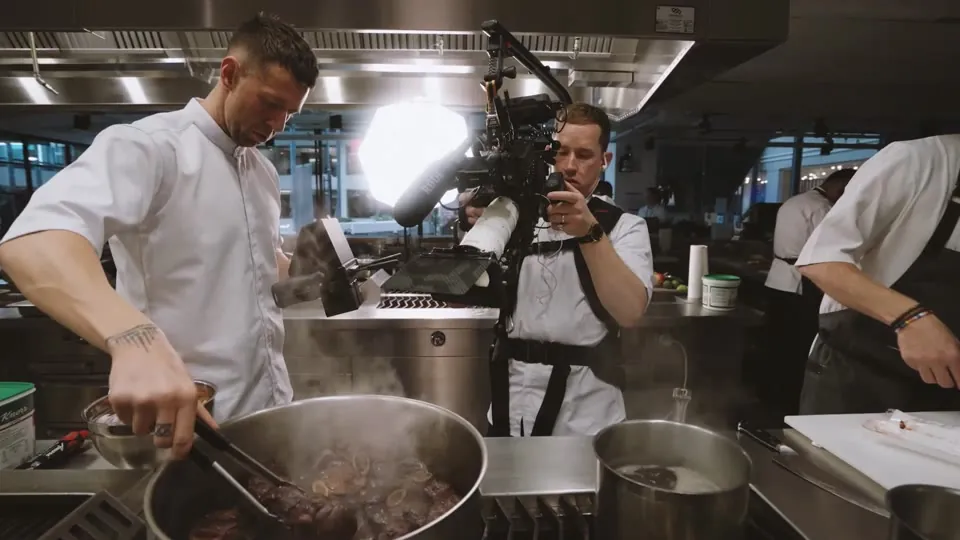 Food Story Media crew filming a chef in a restaurant kitchen